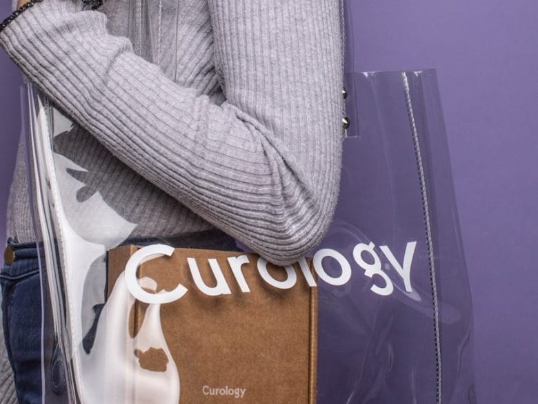 woman wearing clear tote bag