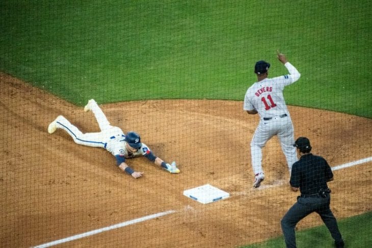 A baseball player sliding into a base during a game